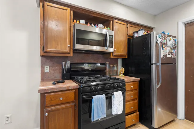 a kitchen with stainless steel appliances granite countertop a sink and cabinets