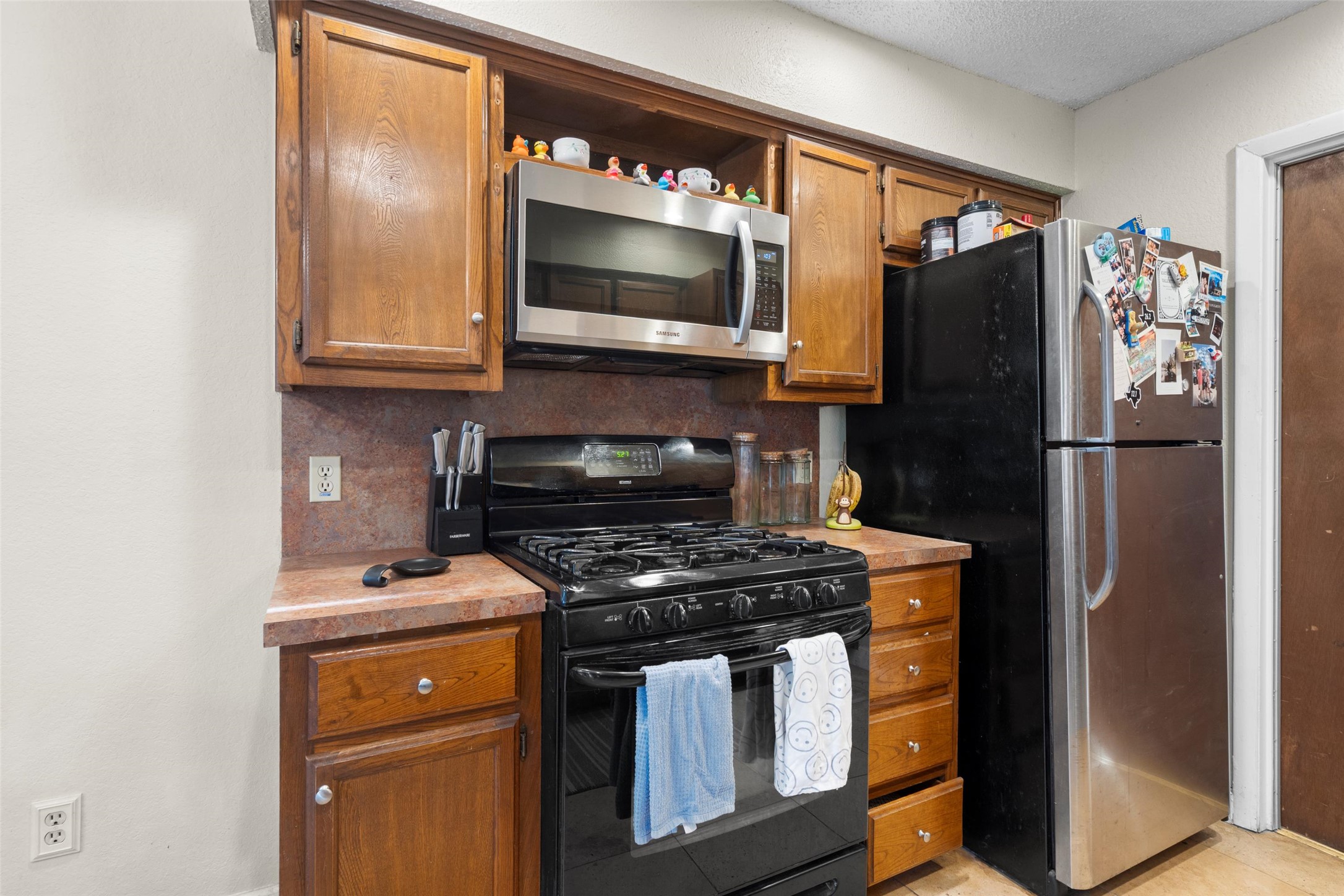 6492 Hart Lane Austin, TX 78731 - Photo 9 of 22 a kitchen with stainless steel appliances granite countertop a refrigerator and a stove
