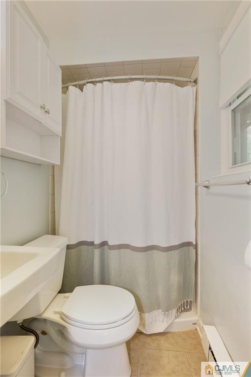 2 Poplar Road Hillsborough, NJ 08844 - Photo 7 of 22 a white toilet sitting next to a bathroom sink and vanity