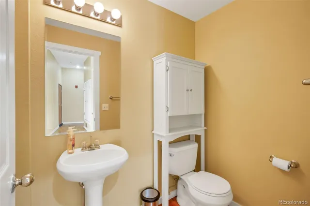 a bathroom with a sink mirror toilet and shower