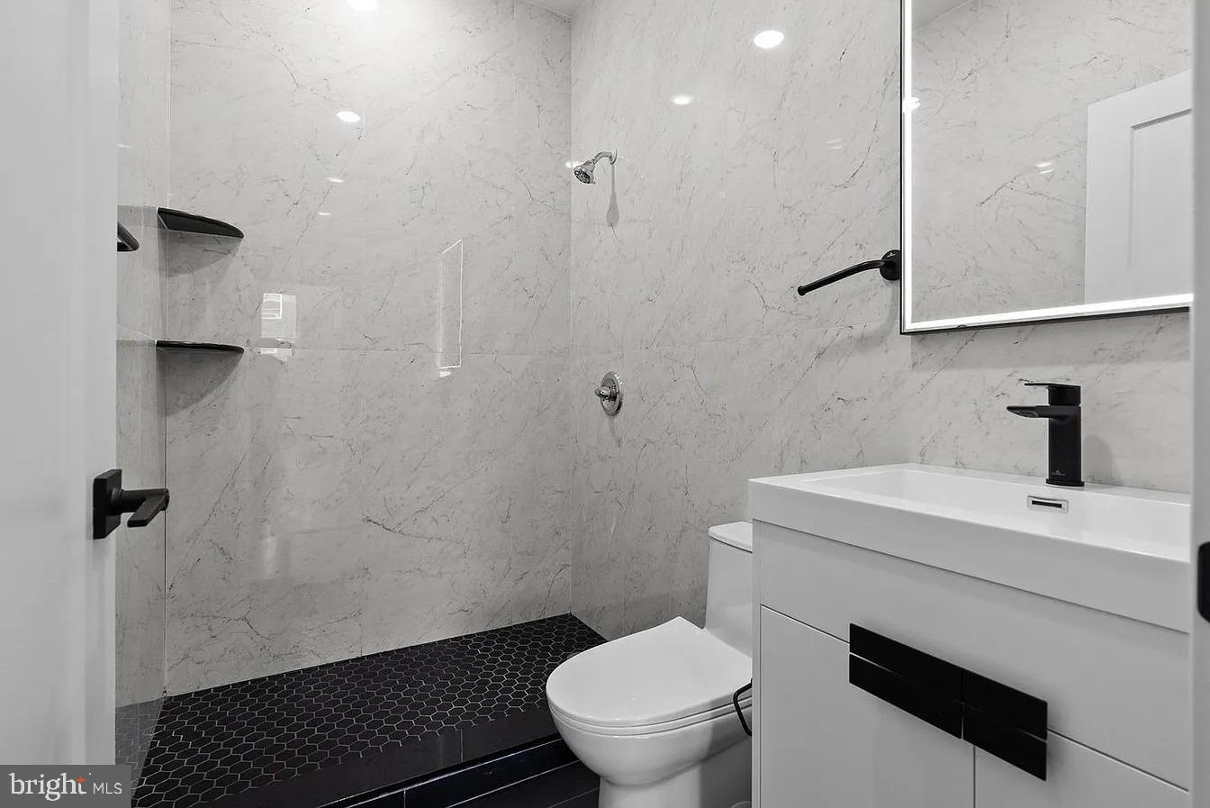 2146 North Front Street, Unit 1 Philadelphia, PA 19122 - Photo 14 of 16 a bathroom with a sink toilet and shower