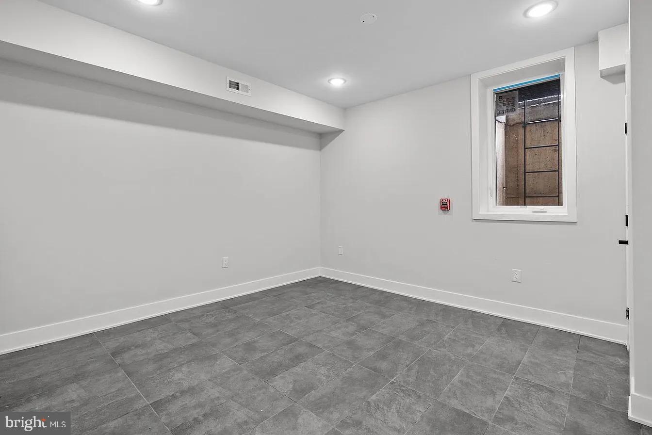 2146 North Front Street, Unit 1 Philadelphia, PA 19122 - Photo 8 of 16 an empty room with windows and closet