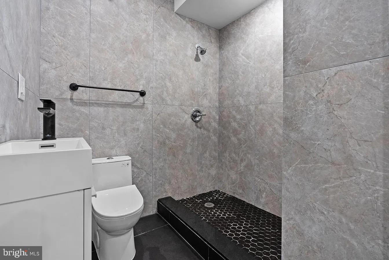 2146 North Front Street, Unit 1 Philadelphia, PA 19122 - Photo 10 of 16 a bathroom with a sink and a toilet