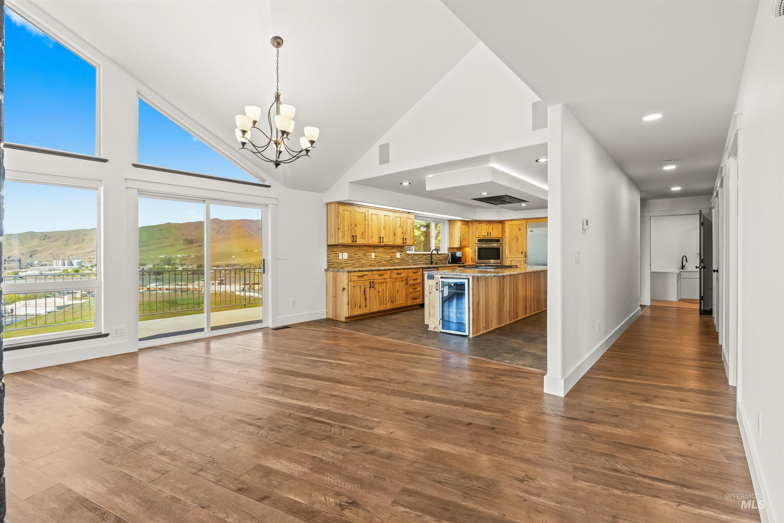 3360 East Main Street Lewiston, ID 83501 - Photo 12 of 50 Vaulted ceilings with an exposed beam, wood-finish flooring, and a kitchen featuring wood cabinetry and a beverage refrigerator