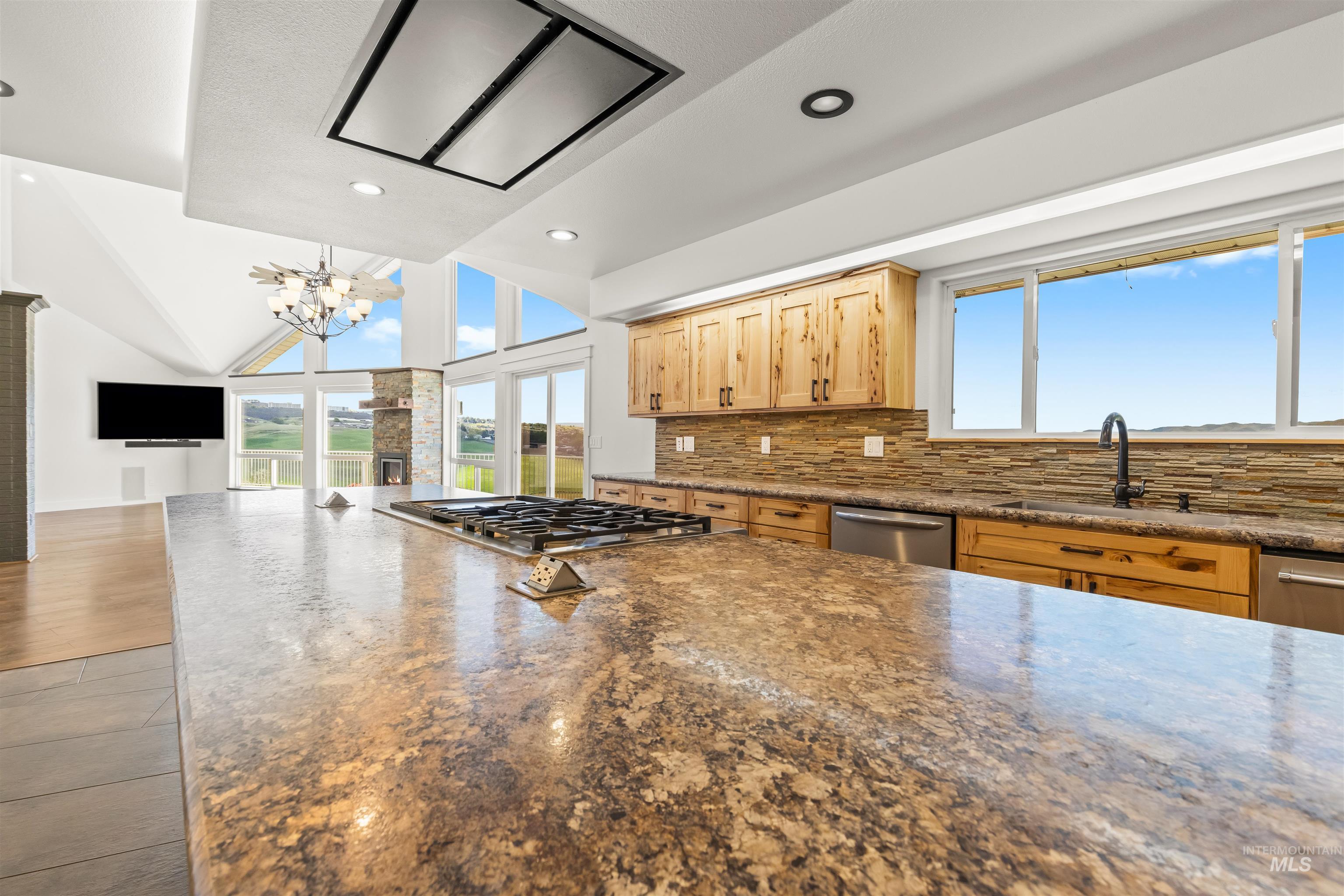 3360 East Main Street Lewiston, ID 83501 - Photo 16 of 50 Expansive kitchen island with a built-in gas cooktop, complemented by light wood cabinetry and stainless steel appliances