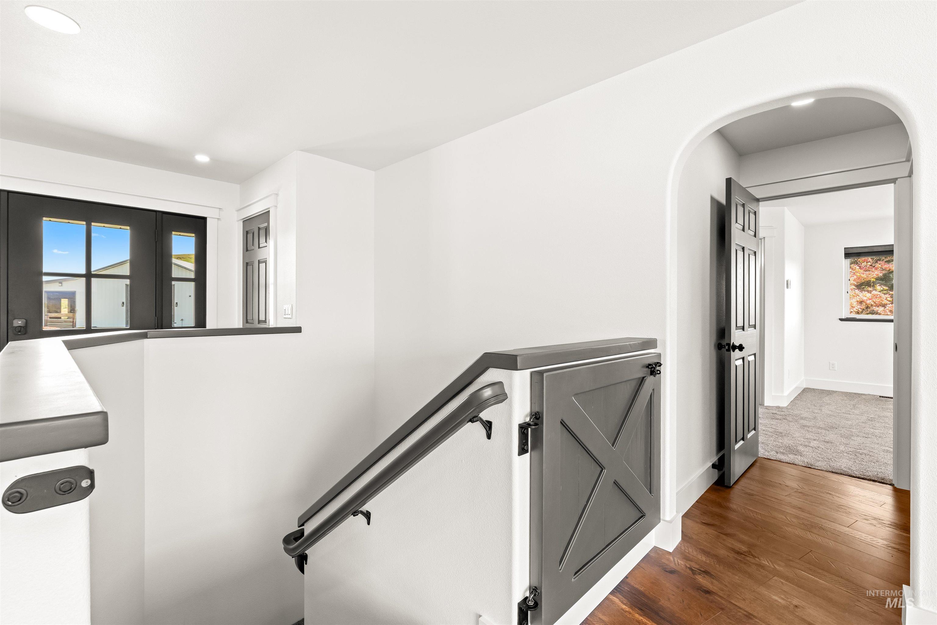 3360 East Main Street Lewiston, ID 83501 - Photo 25 of 50 Upper-level landing featuring a wood-finish floor, white walls, and a dark handrail