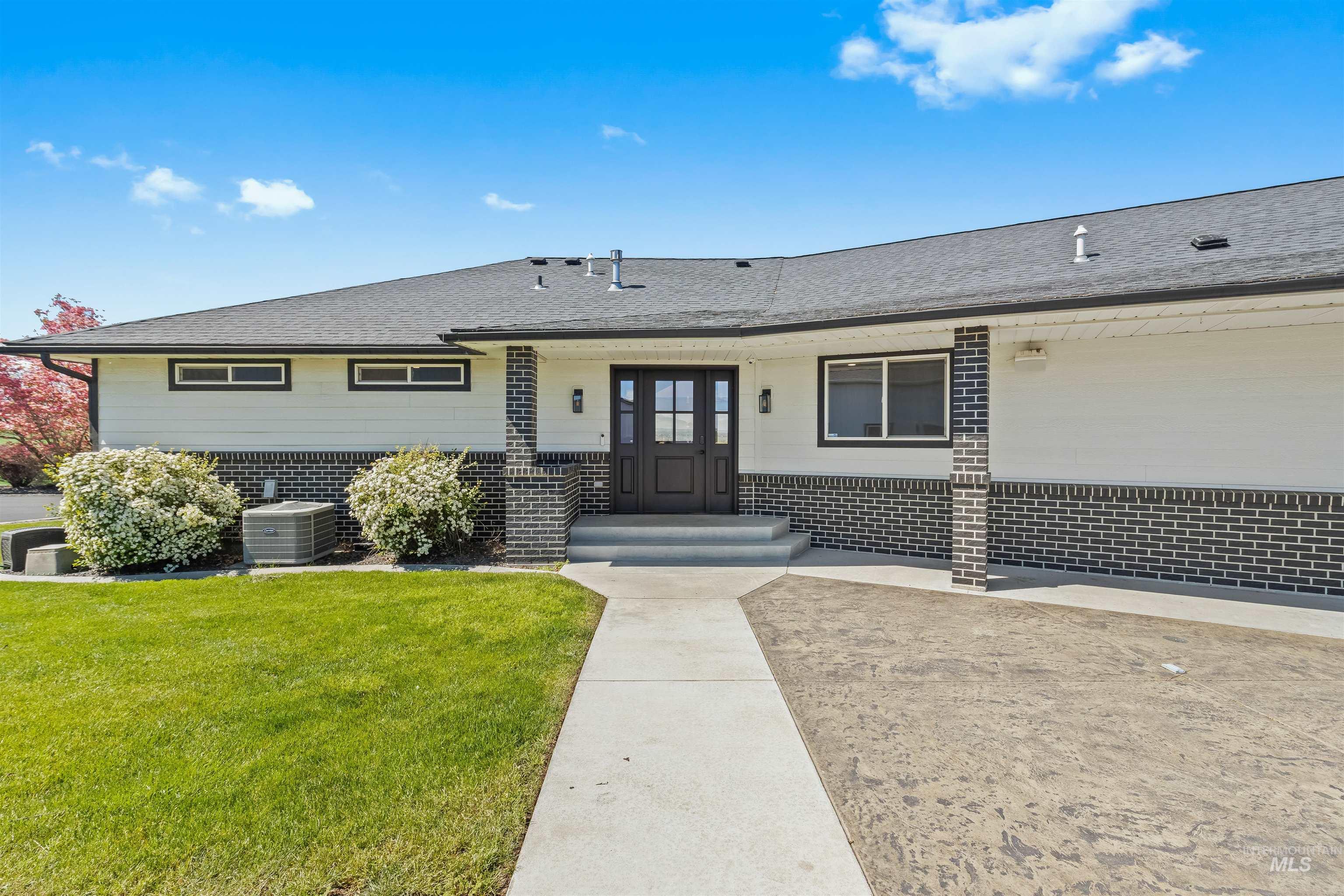 3360 East Main Street Lewiston, ID 83501 - Photo 3 of 50 Modern ranch-style exterior featuring white horizontal siding and a dark brick facade