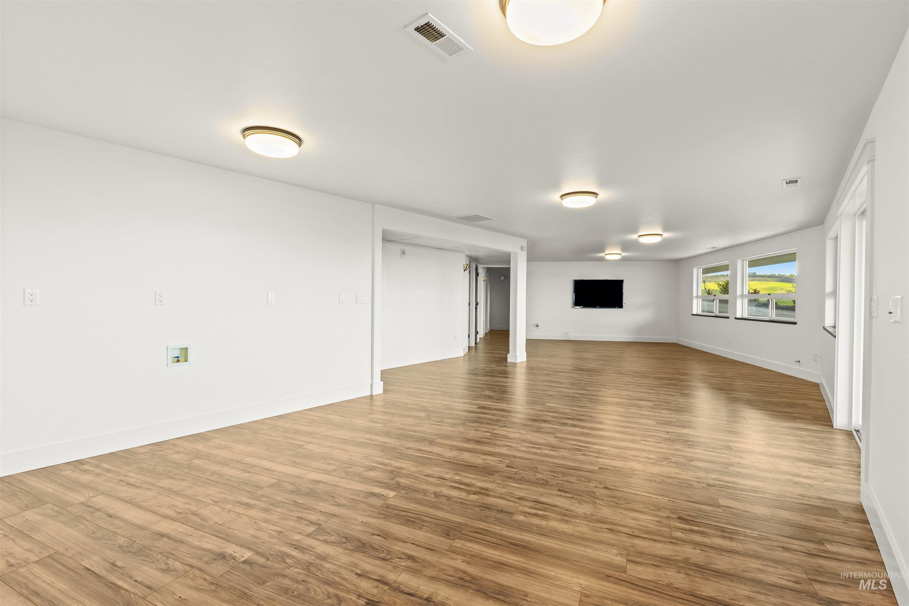 3360 East Main Street Lewiston, ID 83501 - Photo 36 of 50 Spacious room featuring wood-finish flooring, recessed lighting, multiple windows, and white trim