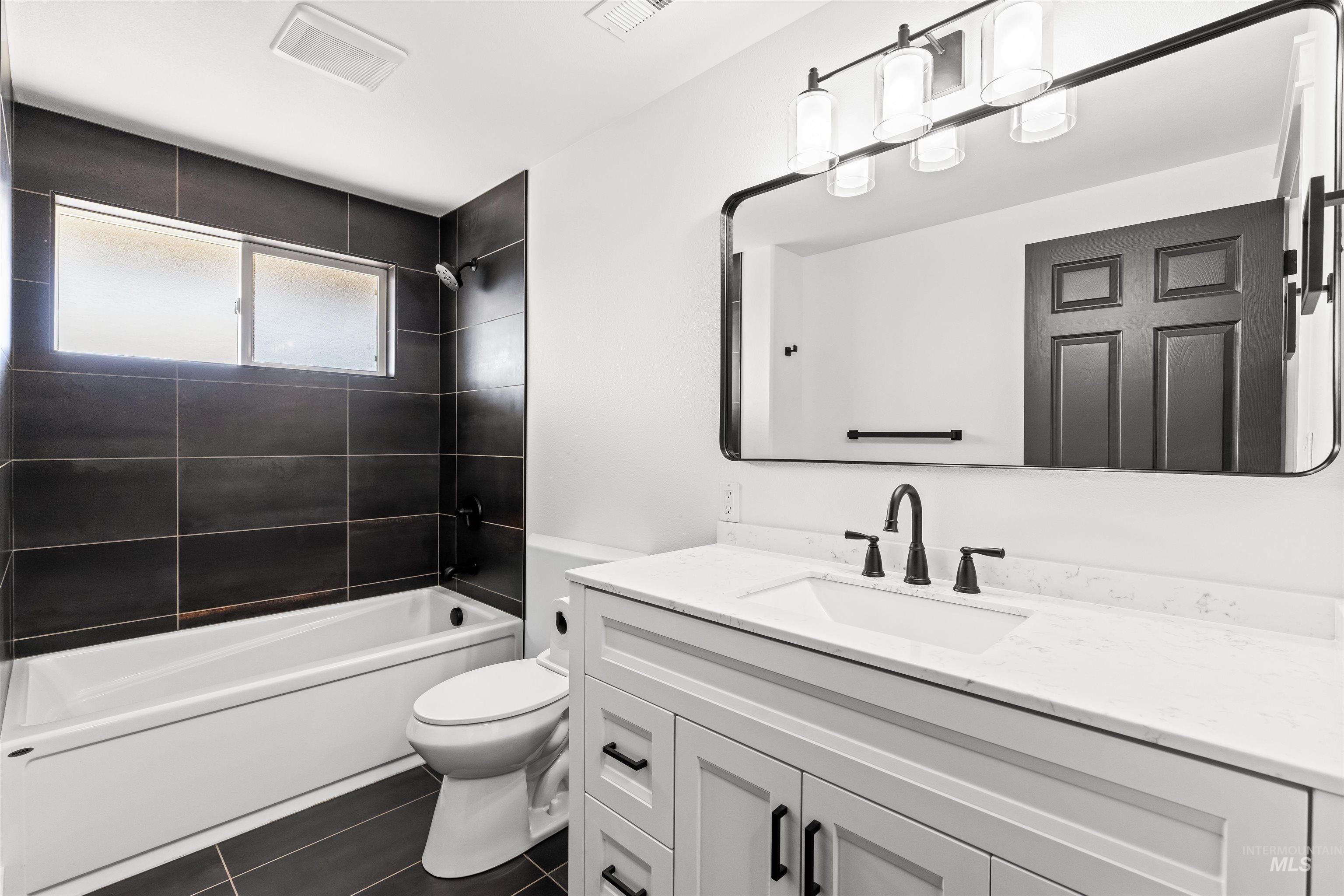 3360 East Main Street Lewiston, ID 83501 - Photo 38 of 50 Bathroom featuring a white vanity with a rectangular undermount sink, a white countertop, and matte black fixtures