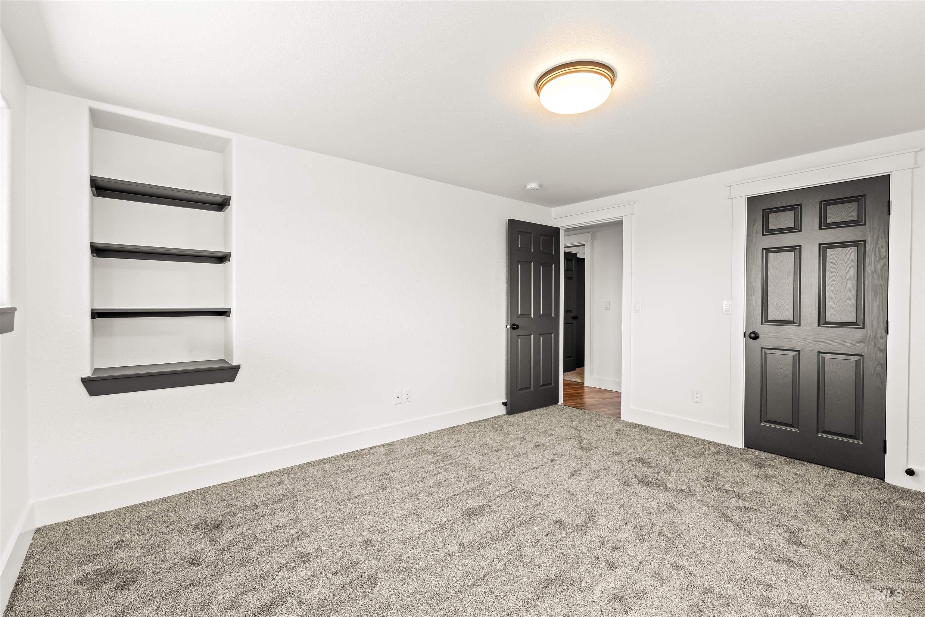 3360 East Main Street Lewiston, ID 83501 - Photo 40 of 50 Room featuring light gray carpet flooring, white walls, and dark paneled doors