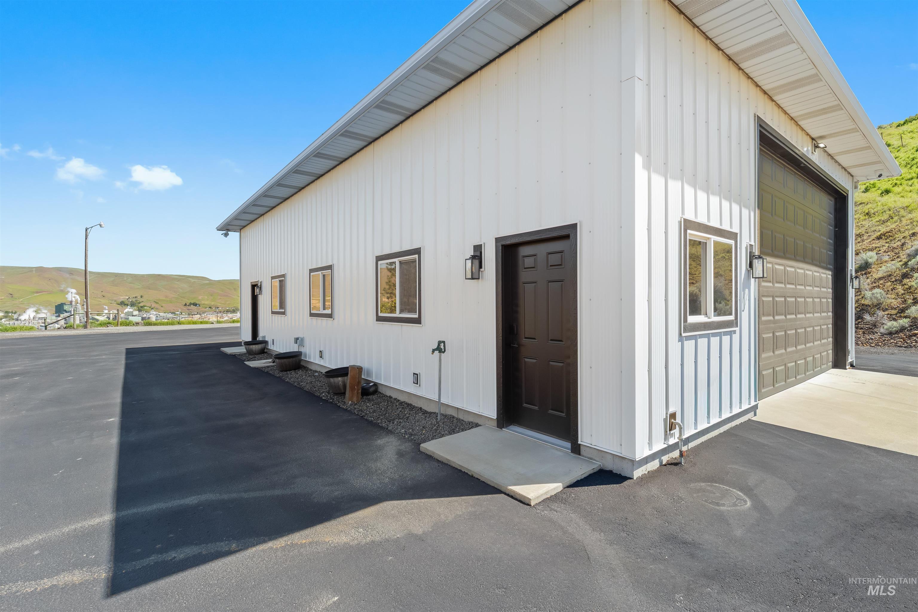 3360 East Main Street Lewiston, ID 83501 - Photo 45 of 50 White vertical siding structure featuring a large asphalt parking area