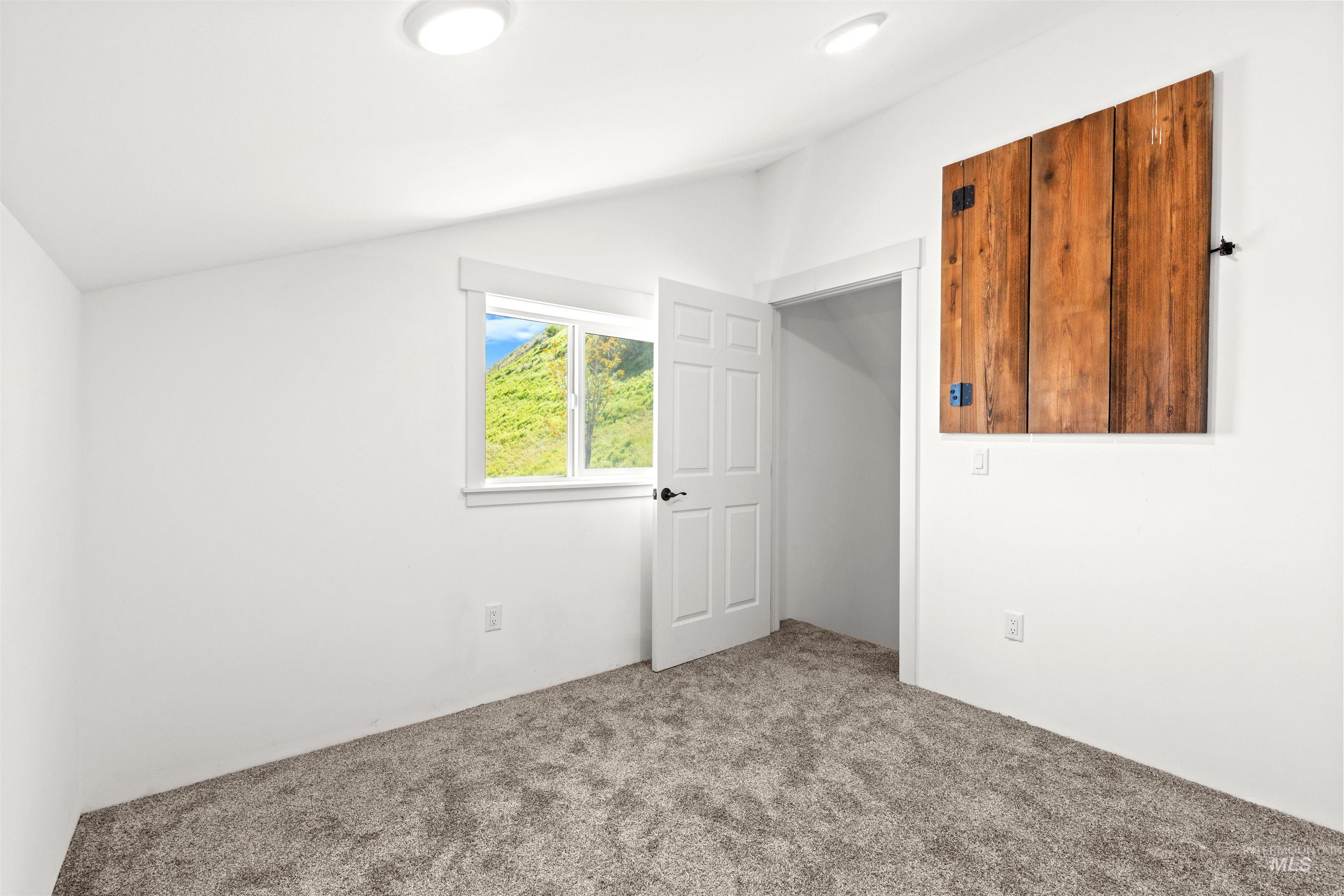 3360 East Main Street Lewiston, ID 83501 - Photo 50 of 50 Bedroom featuring neutral-toned carpeting, white walls, and a window with natural scenery