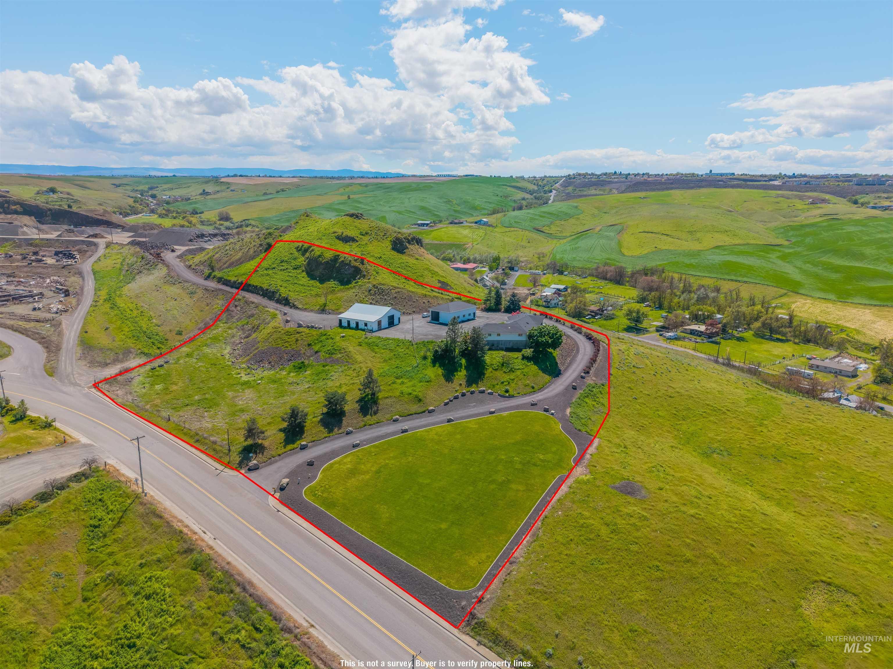 3360 East Main Street Lewiston, ID 83501 - Photo 6 of 50 Expansive property featuring a paved driveway, a large grassy area, and multiple outbuildings