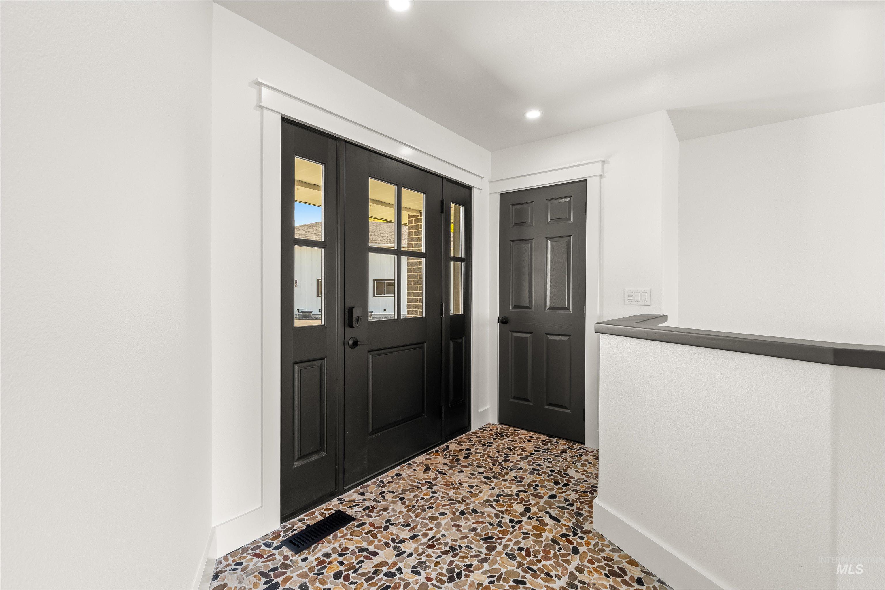 3360 East Main Street Lewiston, ID 83501 - Photo 7 of 50 Entryway featuring double black doors with glass paneling, a pebble-finish floor, recessed lighting, and a white interior wall finish