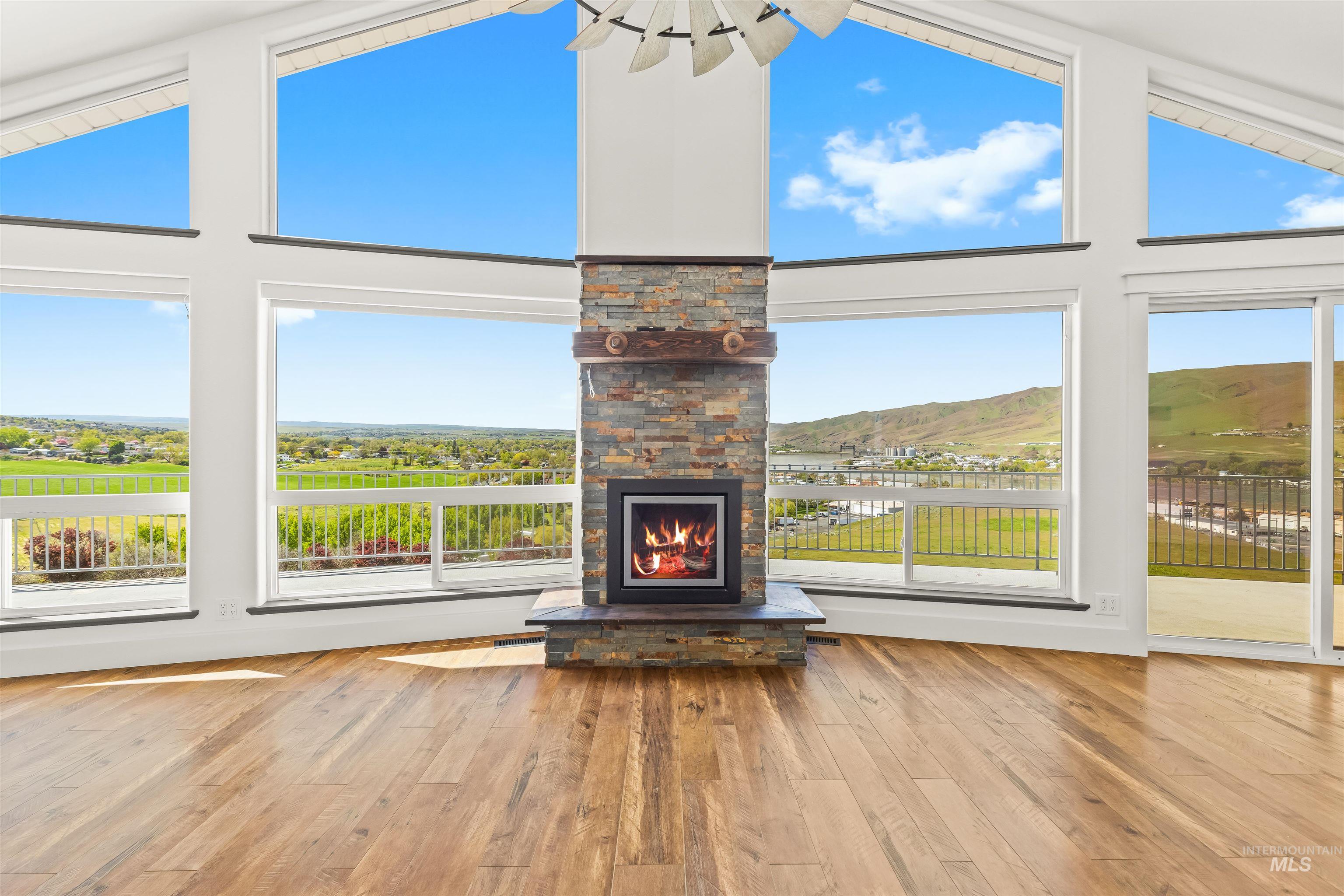 3360 East Main Street Lewiston, ID 83501 - Photo 10 of 50 Hardwood flooring throughout this room featuring a floor-to-ceiling stone fireplace with a substantial wood mantel