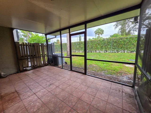 a view of a room with wooden floor and iron stairs