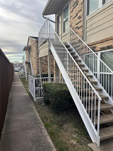a view of balcony with wooden floor and fence