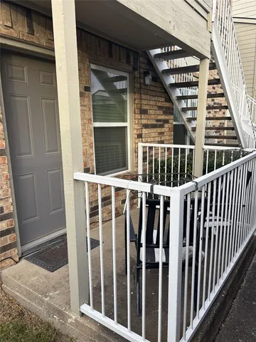 a view of a balcony with staircase