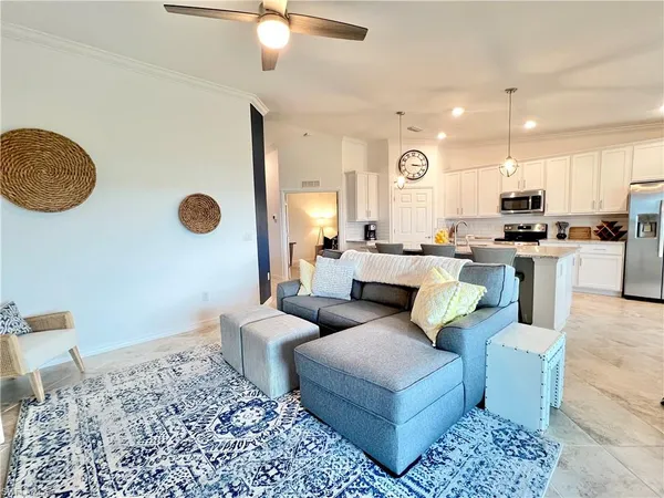 a living room with furniture and a chandelier