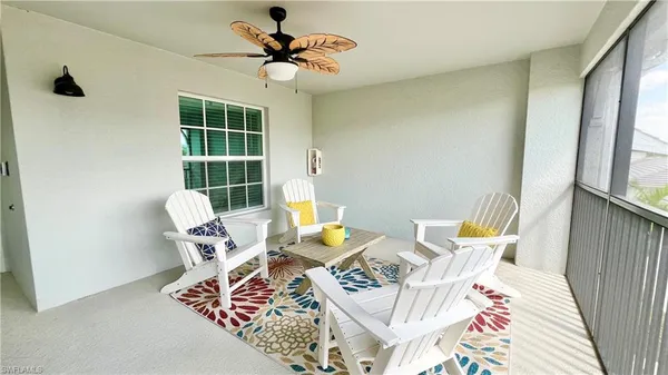 a balcony with furniture and a floor to ceiling window