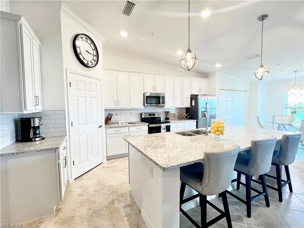 a kitchen with a table and chairs in it