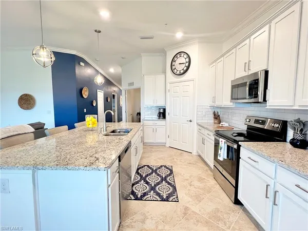 a living room with furniture a chandelier and a mirror