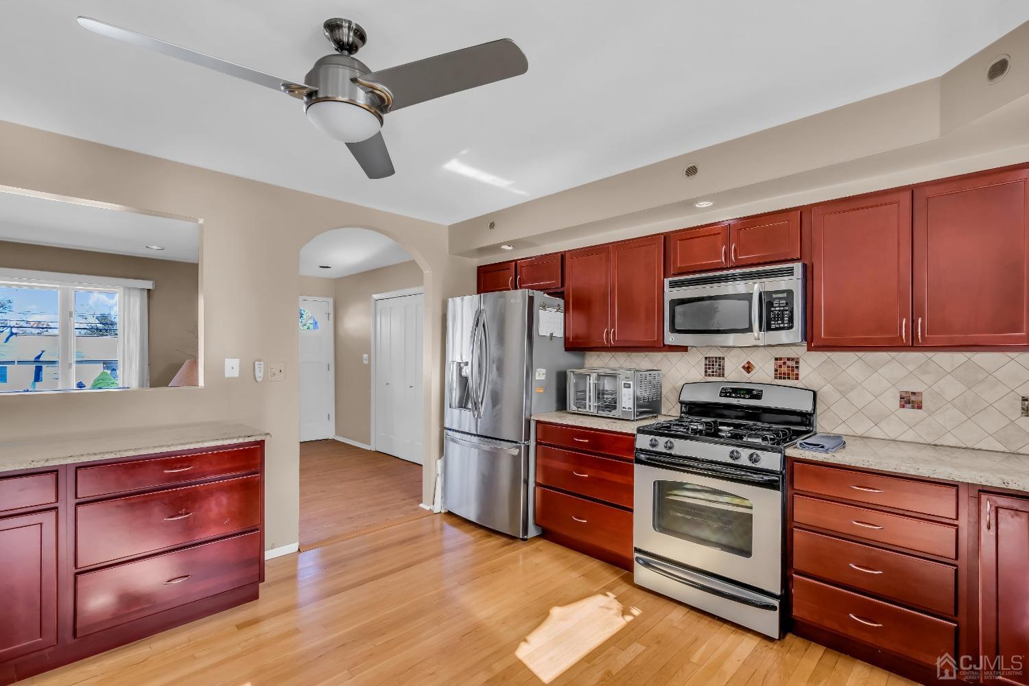 6 Georgetown Road Old Bridge, NJ 08859 - Photo 13 of 45 a kitchen with stainless steel appliances a stove microwave and refrigerator