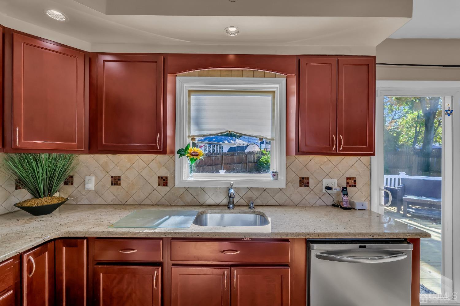 6 Georgetown Road Old Bridge, NJ 08859 - Photo 19 of 45 a kitchen with stainless steel appliances granite countertop a sink a microwave cabinets and a potted plant