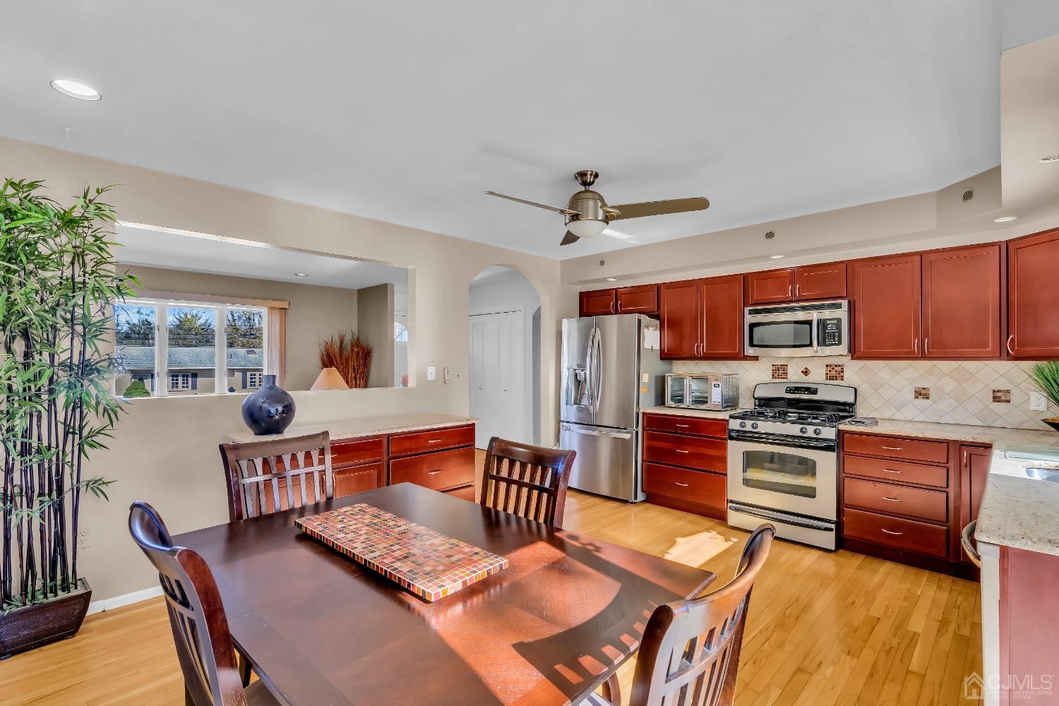 6 Georgetown Road Old Bridge, NJ 08859 - Photo 20 of 45 a kitchen with stainless steel appliances granite countertop a stove top oven a sink a dining table and chairs