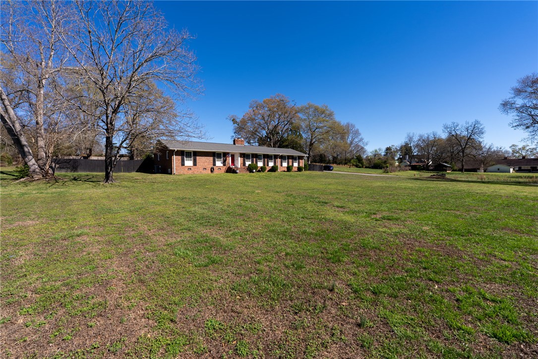 300 Green Street Williamston, SC 29697 - Photo 32 of 47 This ranch-style home sits on a spacious green lot, offering expansive outdoor living potential.