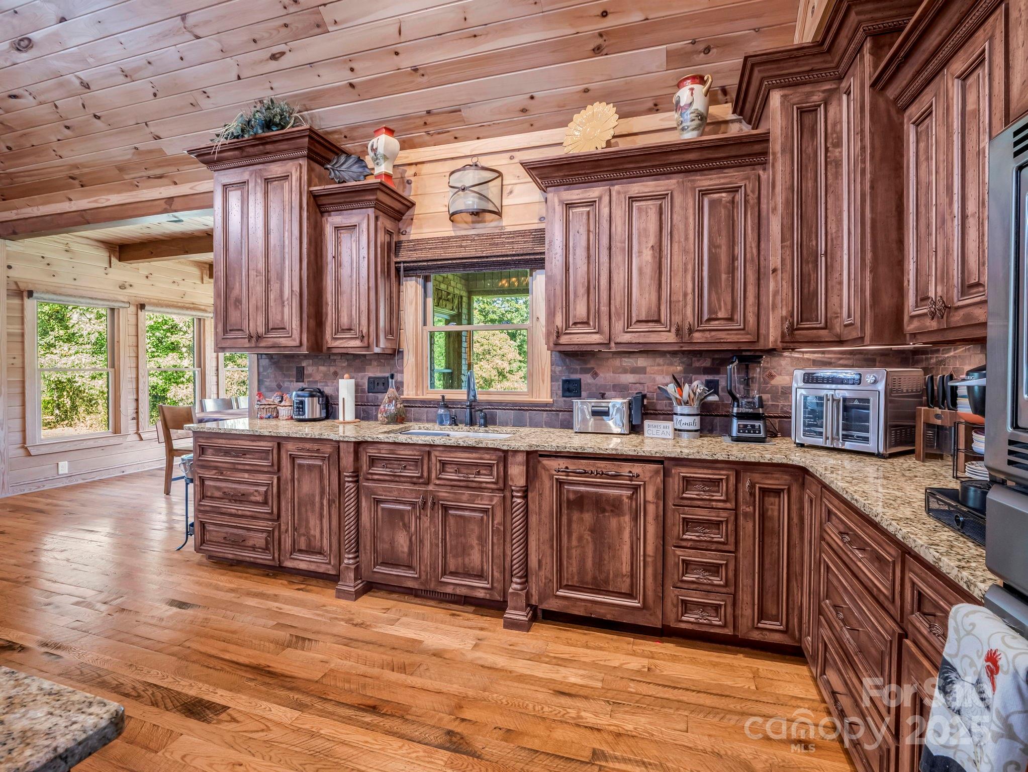 1235 Bob Falls Road Shelby, NC 28150 - Photo 13 of 47 a kitchen with stainless steel appliances granite countertop wooden cabinets a sink and a stove