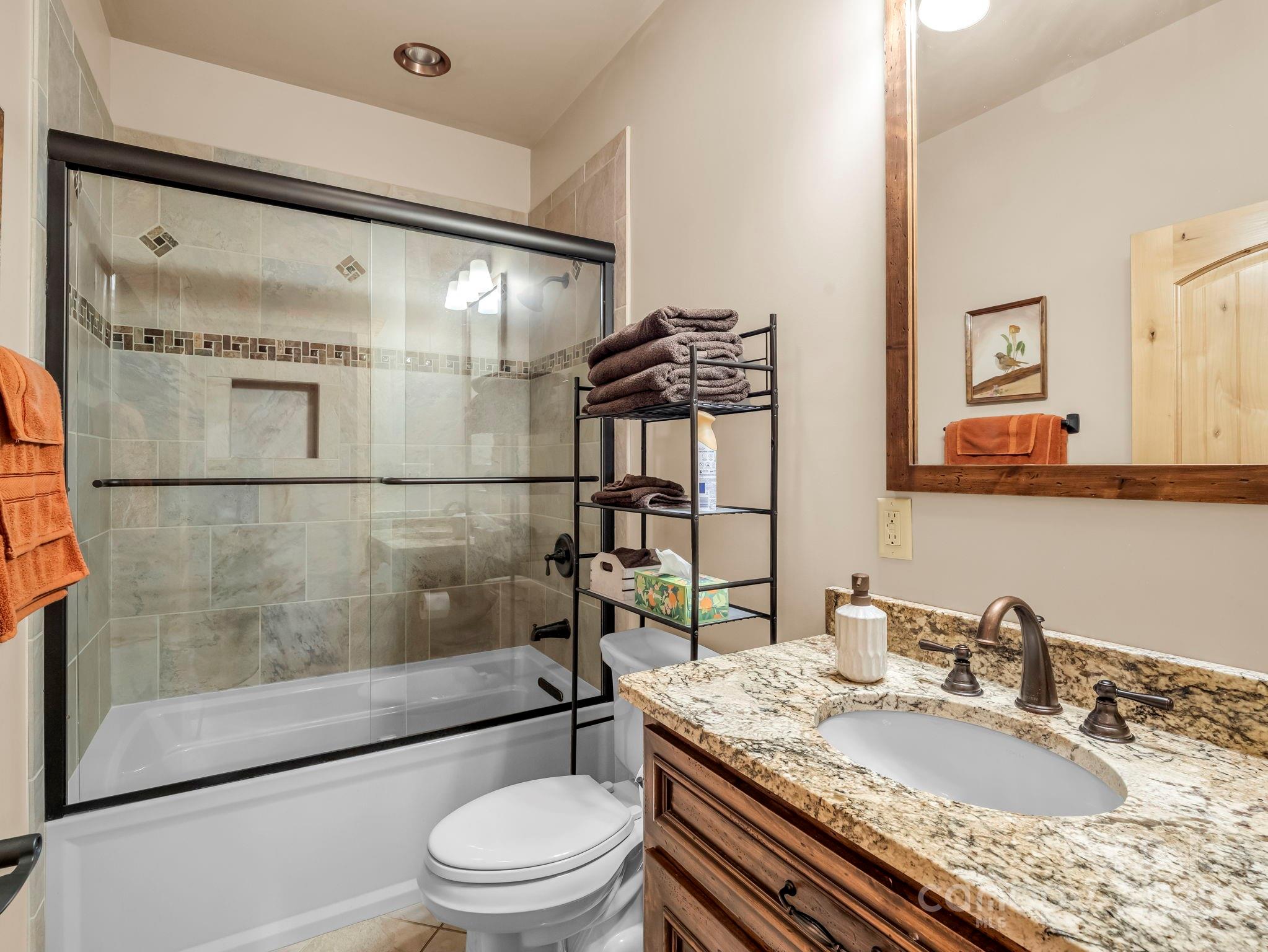 1235 Bob Falls Road Shelby, NC 28150 - Photo 25 of 47 a bathroom with a granite countertop sink toilet a mirror and shower
