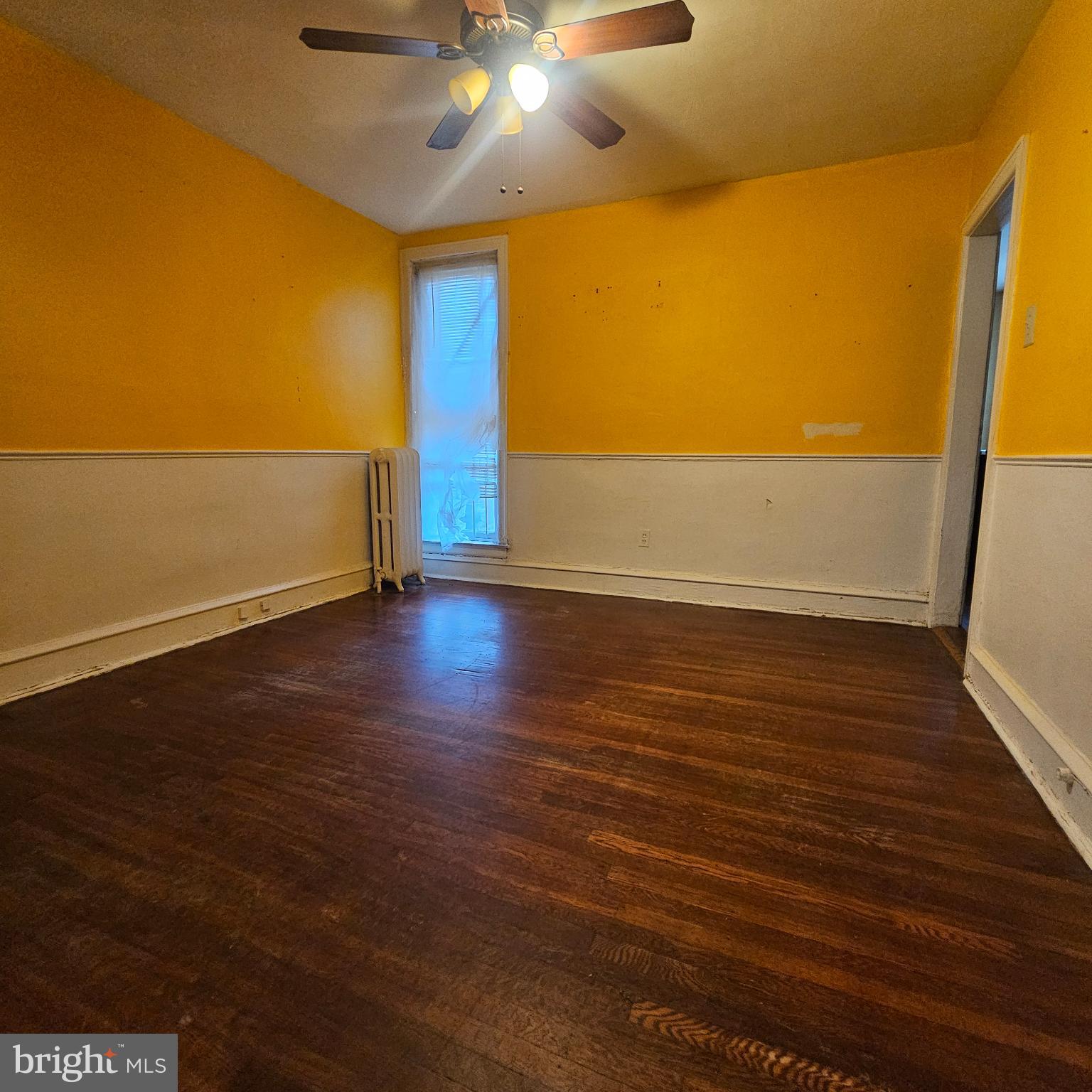 144 Fern Street Philadelphia, PA 19120 - Photo 3 of 12 wooden floor in an empty room with a window