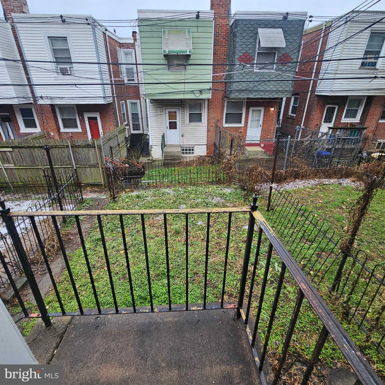 144 Fern Street Philadelphia, PA 19120 - Photo 5 of 12 a view of brick house with large windows and a yard