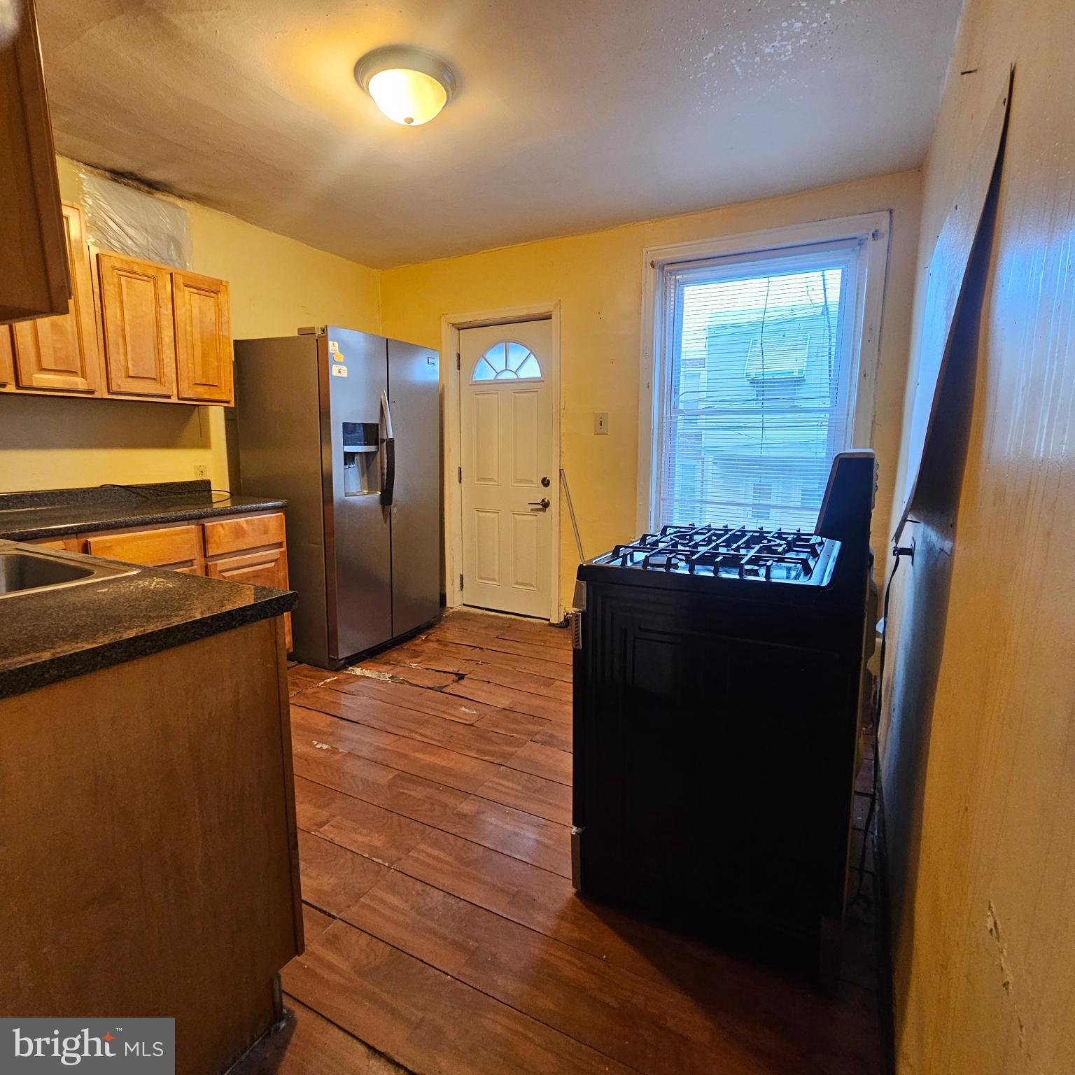 144 Fern Street Philadelphia, PA 19120 - Photo 7 of 12 a kitchen with stainless steel appliances granite countertop a refrigerator and a stove