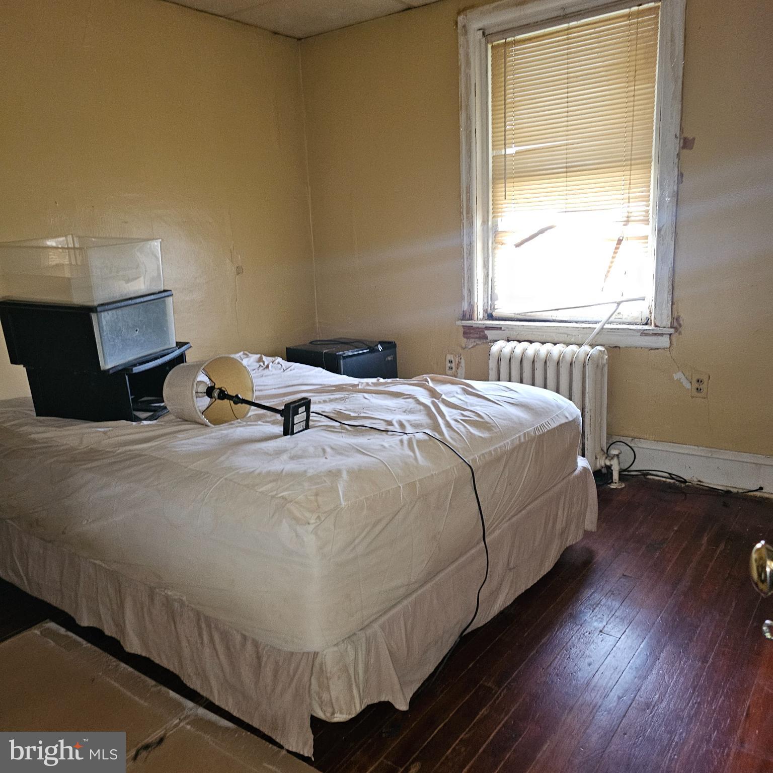 144 Fern Street Philadelphia, PA 19120 - Photo 9 of 12 a bed sitting in a bedroom next to a window