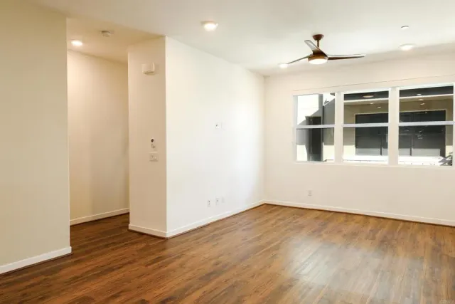 a kitchen with kitchen island granite countertop a refrigerator and a stove top oven