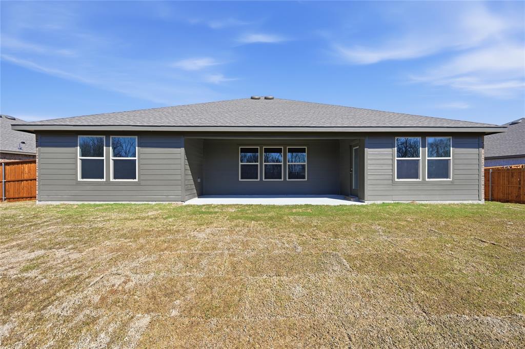 1905 Reveille Way Terrell, TX 75160 - Photo 3 of 6 Rear exterior featuring gray horizontal siding, a covered patio, and a shingle roof