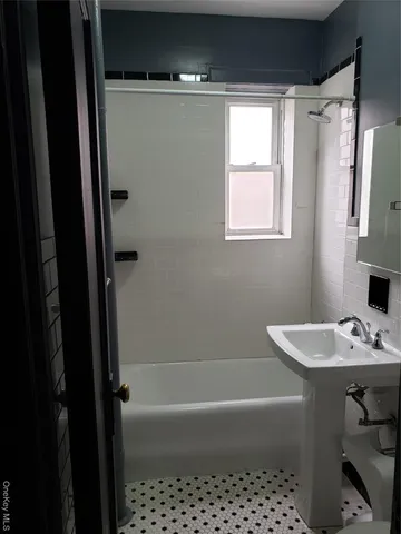 a bathroom with a bathtub a sink a vanity and a shower