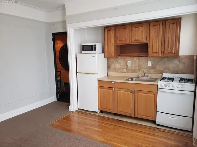 a kitchen with stainless steel appliances granite countertop a refrigerator sink and cabinets