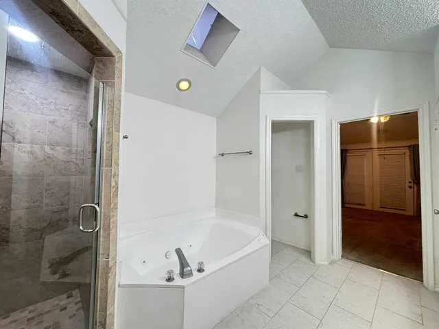a bathroom with a bathtub and a shower