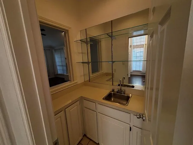 a bathroom with a sink and mirror