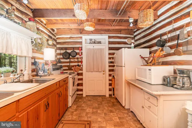 a kitchen with refrigerator and cabinets
