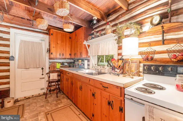 a kitchen with a stove a sink and a refrigerator
