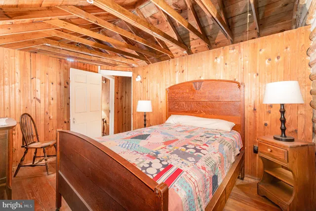 a bedroom with a bed a table and chair