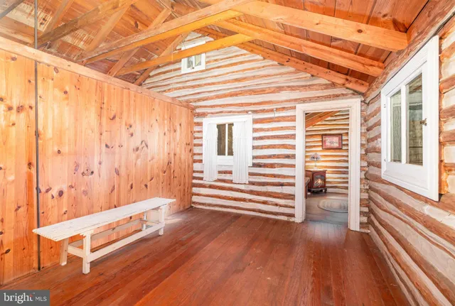 a view of a room with wooden floor and furniture