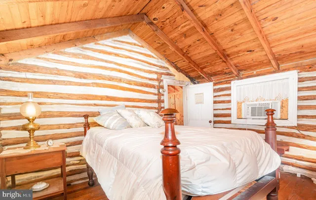 a bed sitting in a bedroom next to a window