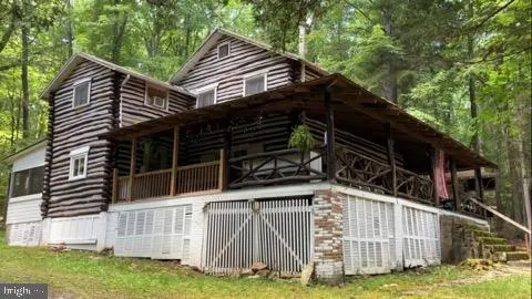 a view of house with backyard