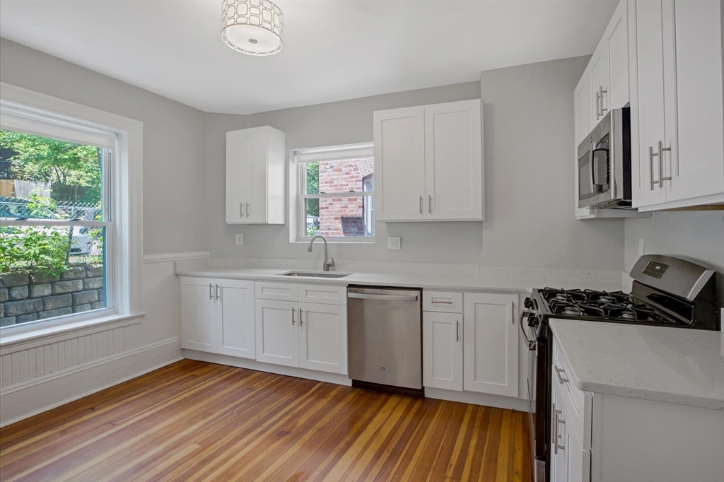 116 Winthrop Road, Unit 3 Brookline, MA 02445 - Photo 3 of 21 a kitchen with sink window and cabinets