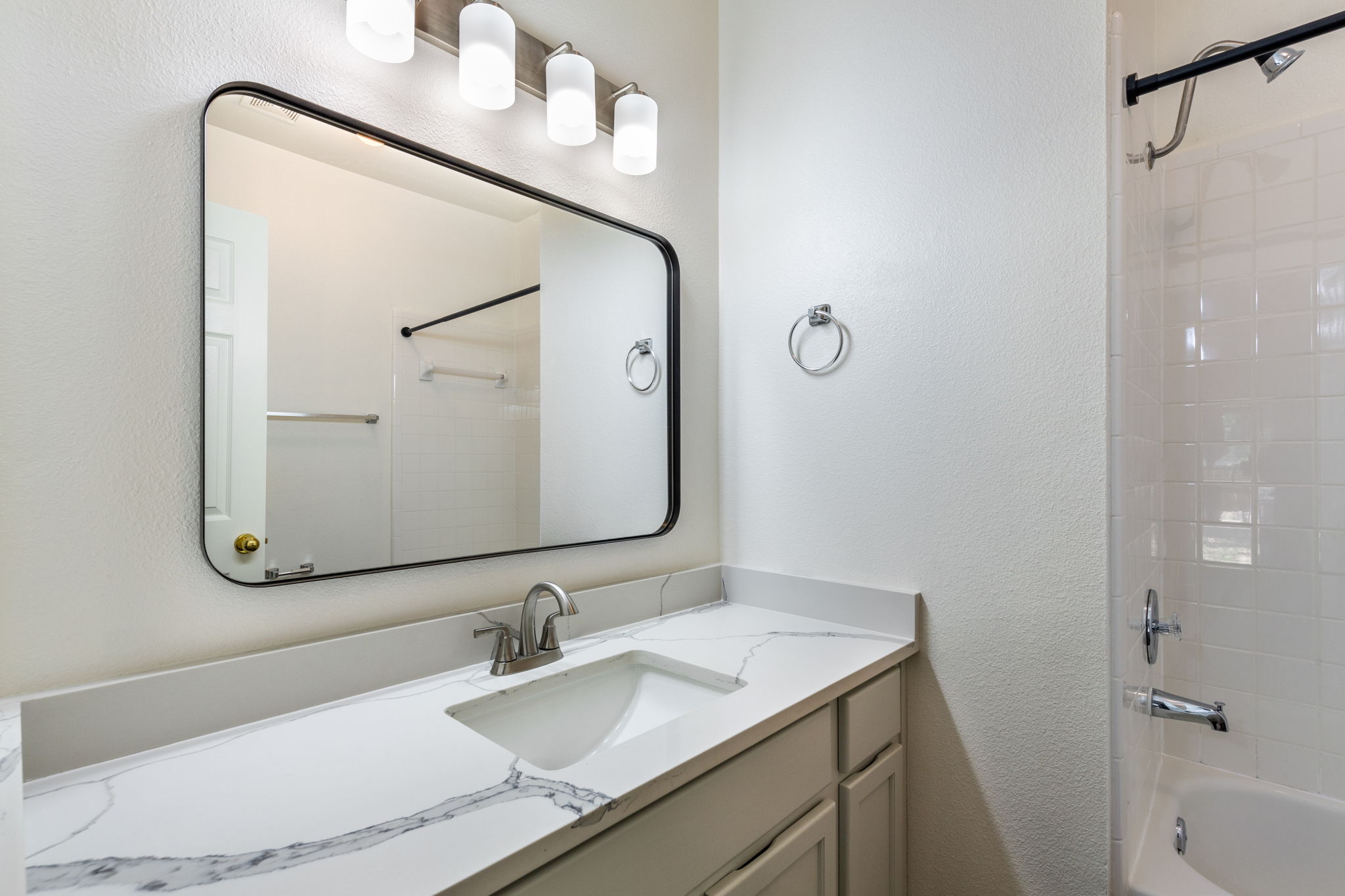 8708 Weiser Drive, Unit B Austin, TX 78729 - Photo 17 of 30 a bathroom with a granite countertop sink and a mirror